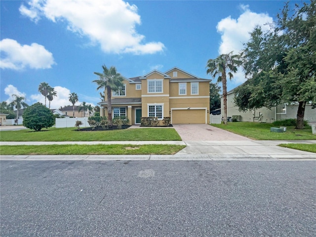 view of front facade with a garage and a front lawn