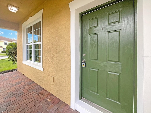 property entrance featuring stucco siding