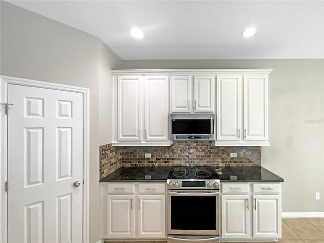 kitchen with appliances with stainless steel finishes, decorative backsplash, and white cabinets