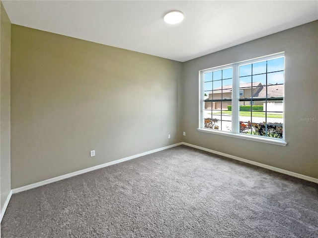 spare room with carpet flooring and baseboards