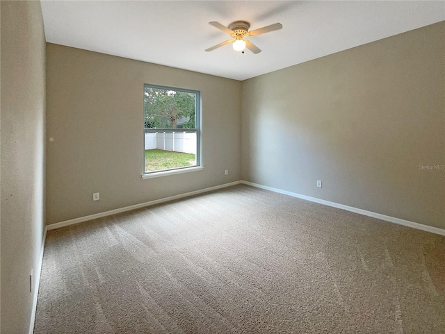 unfurnished room featuring ceiling fan, carpet floors, and baseboards