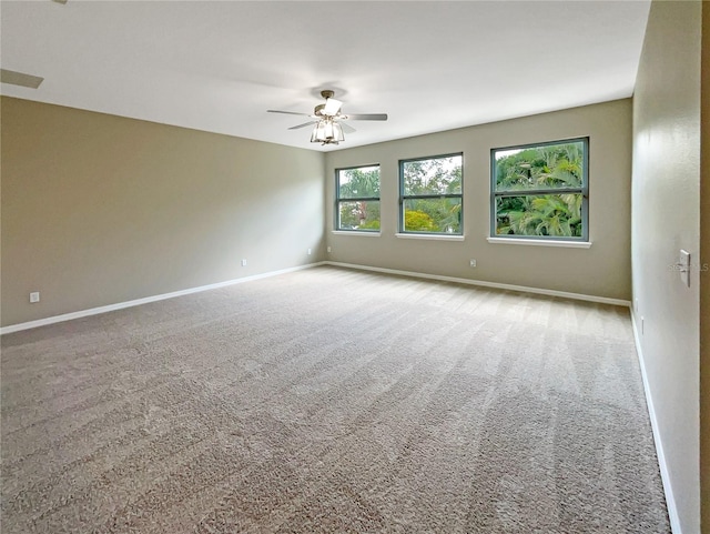 unfurnished room featuring light carpet, ceiling fan, and baseboards