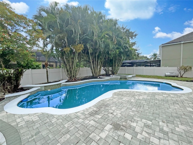 view of pool featuring a fenced backyard, a fenced in pool, and an in ground hot tub