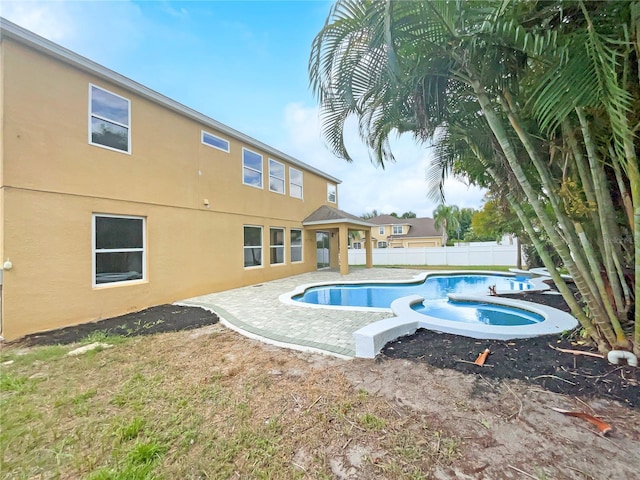 view of pool featuring a patio, an outdoor hot tub, fence, and a fenced in pool