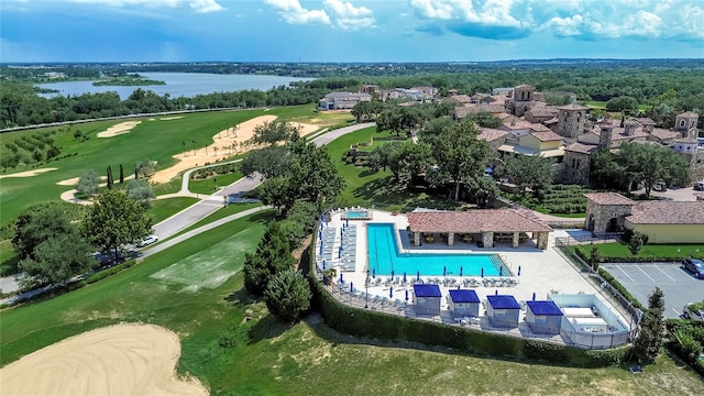 drone / aerial view with a water view and golf course view