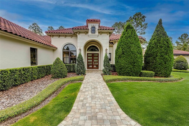 exterior space with a lawn and french doors