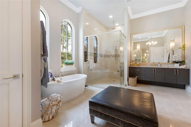 full bath with ornamental molding, a shower stall, vanity, a freestanding tub, and tile patterned floors