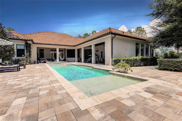 outdoor pool with a patio area