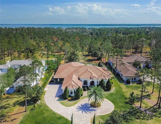 aerial view with a forest view and a water view