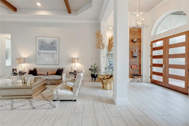 foyer featuring wood finish floors, french doors, beam ceiling, a towering ceiling, and baseboards