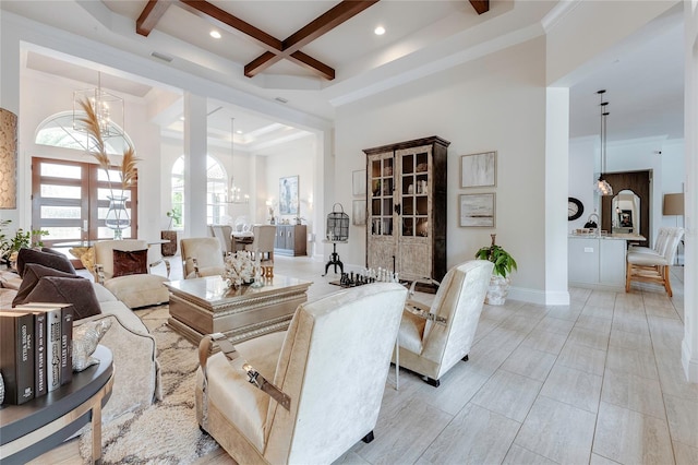 living area featuring a notable chandelier, a high ceiling, coffered ceiling, beamed ceiling, and baseboards