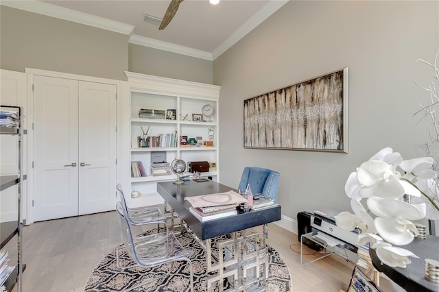 office with light wood finished floors, visible vents, ornamental molding, a ceiling fan, and baseboards