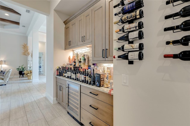 bar featuring baseboards, visible vents, wine cooler, a bar, and beam ceiling