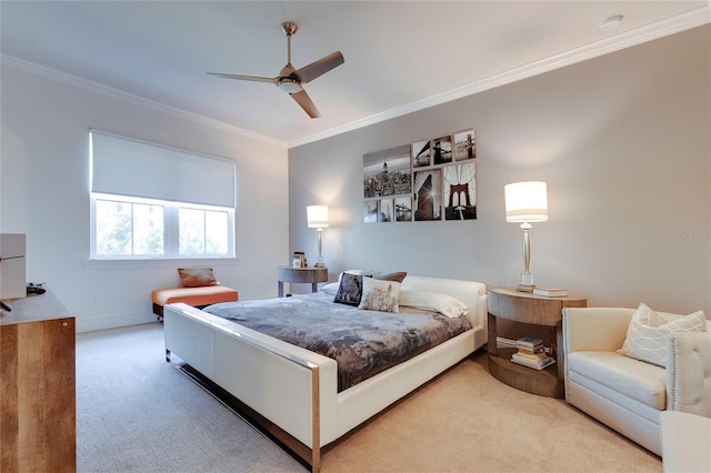 carpeted bedroom with baseboards, ornamental molding, and a ceiling fan