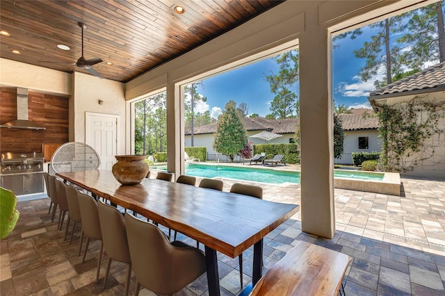 view of patio / terrace with outdoor dining space, an outdoor pool, area for grilling, and ceiling fan