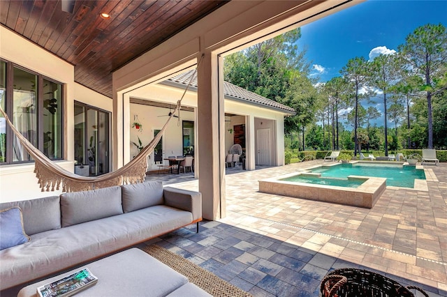 exterior space featuring ceiling fan, a patio, a pool with connected hot tub, and an outdoor living space