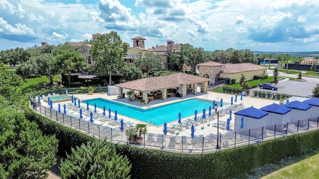 pool featuring fence and a patio