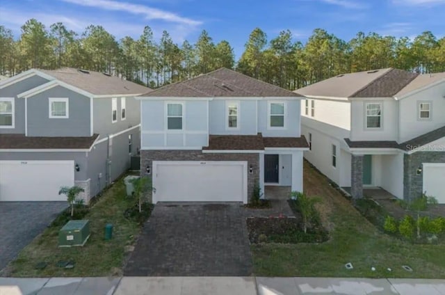 view of front of property featuring central air condition unit and a garage