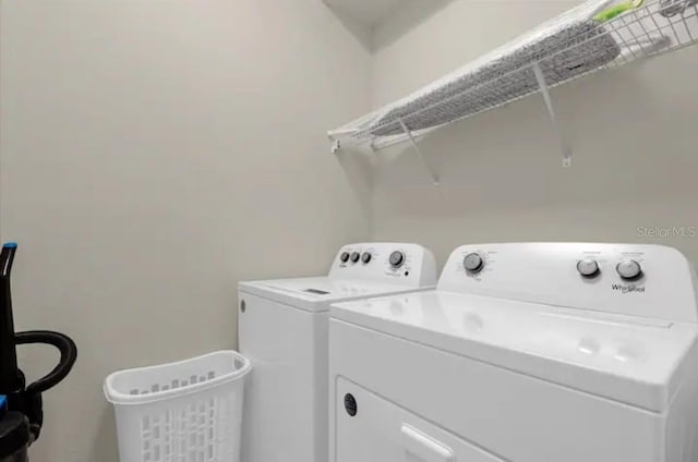 clothes washing area featuring washer and dryer