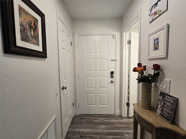 entryway with dark hardwood / wood-style flooring