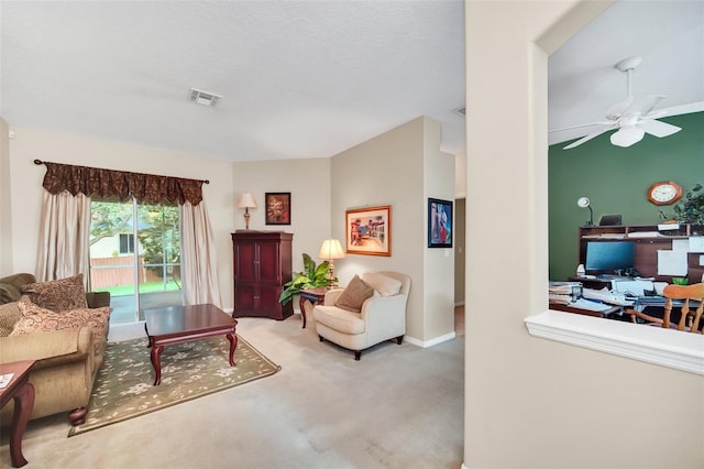 living room featuring carpet flooring, ceiling fan, and vaulted ceiling