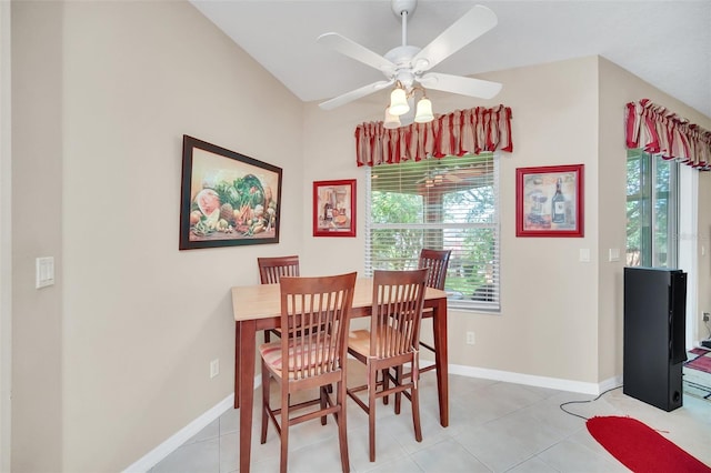 tiled dining room featuring ceiling fan, lofted ceiling, and a wealth of natural light