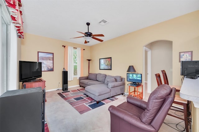 living room with ceiling fan and light colored carpet