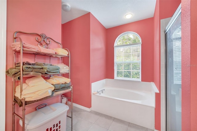 bathroom featuring tile patterned flooring and a bathing tub