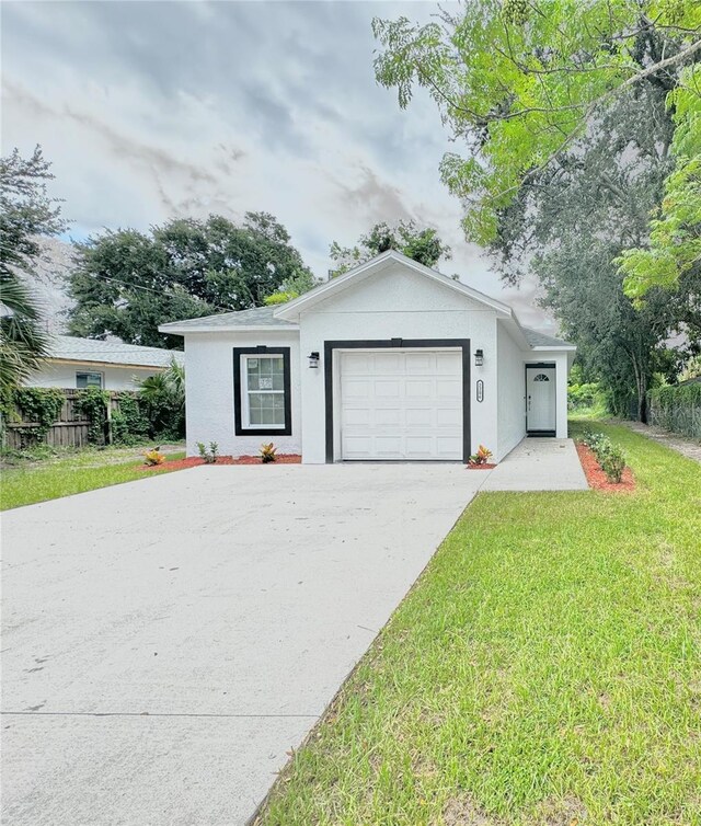 ranch-style house with a garage and a front lawn