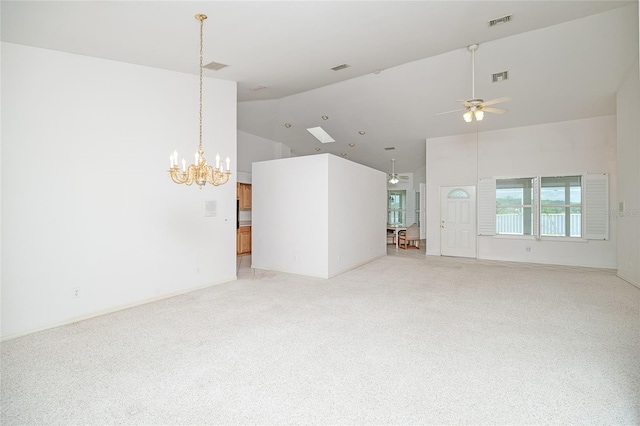 unfurnished living room with ceiling fan with notable chandelier, high vaulted ceiling, light carpet, and visible vents