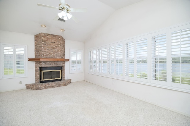 unfurnished living room featuring carpet floors, plenty of natural light, a fireplace, and vaulted ceiling