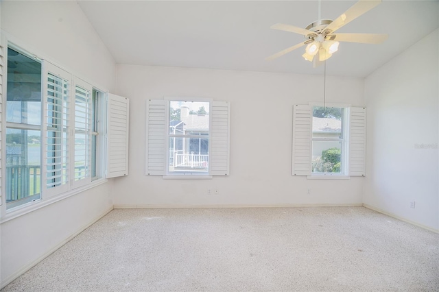 unfurnished room featuring carpet floors, ceiling fan, and baseboards