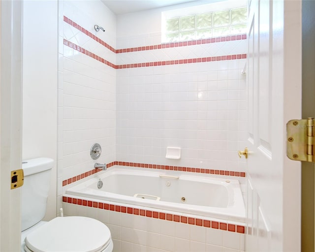 bathroom with toilet and a combined bath / shower with jetted tub