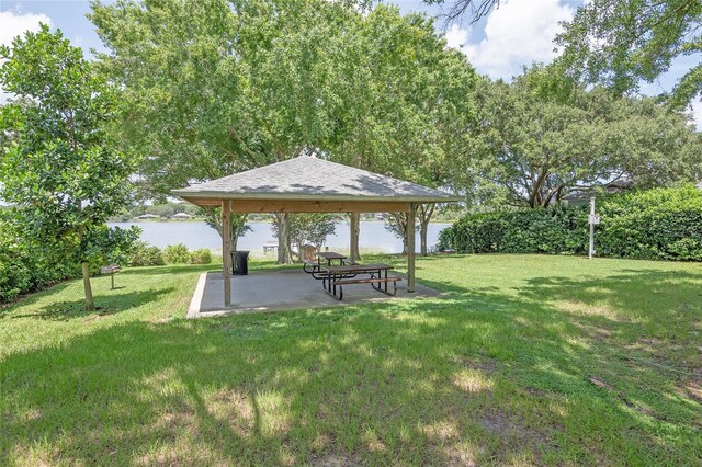 view of yard featuring a water view, a patio, and a gazebo