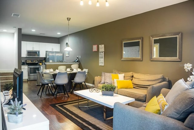 living room with dark hardwood / wood-style flooring