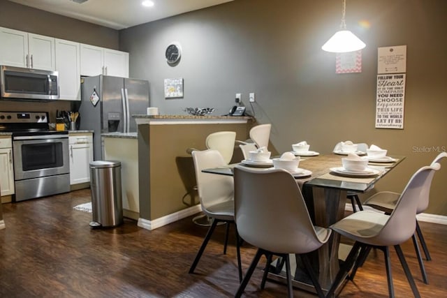 dining area featuring dark hardwood / wood-style flooring