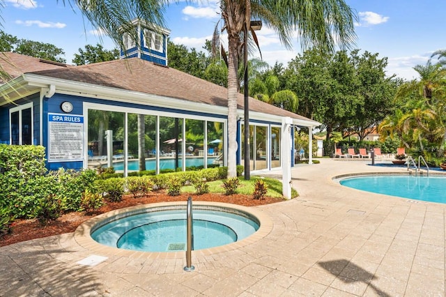 view of swimming pool featuring a community hot tub