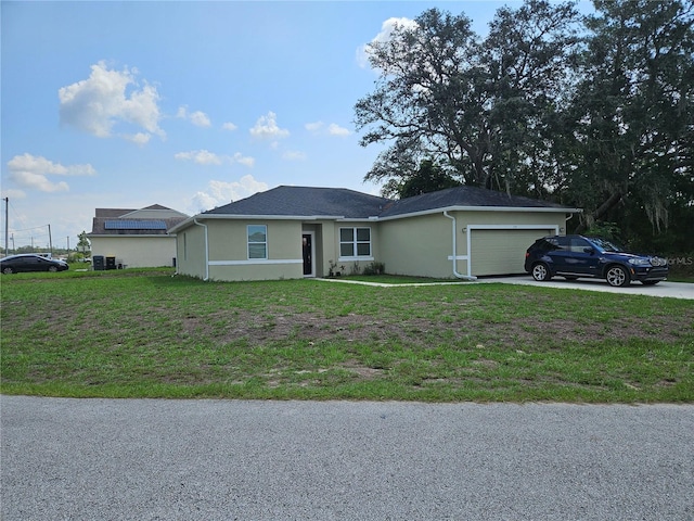 ranch-style house with solar panels, a garage, and a front yard