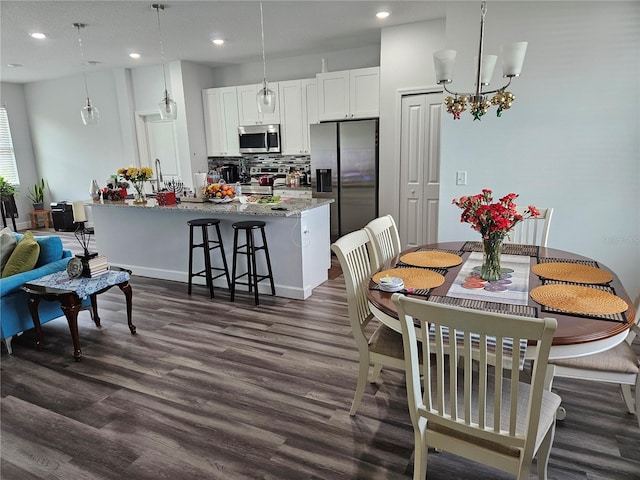 dining space featuring a notable chandelier and dark hardwood / wood-style floors