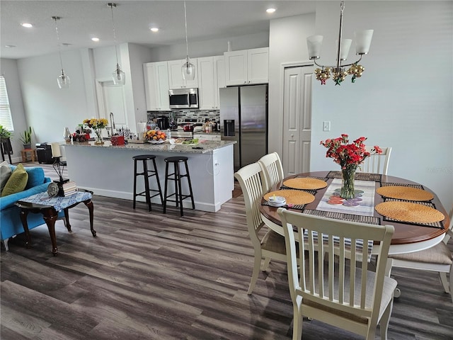 dining room with a chandelier and dark hardwood / wood-style flooring