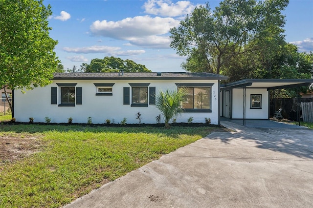 single story home with a front lawn and a carport