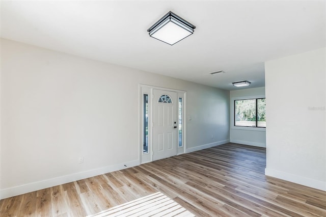 foyer entrance with light hardwood / wood-style floors