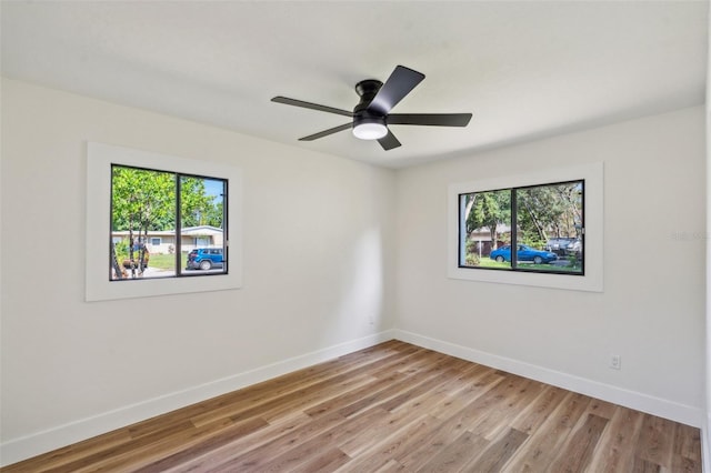 spare room featuring ceiling fan and light wood-type flooring