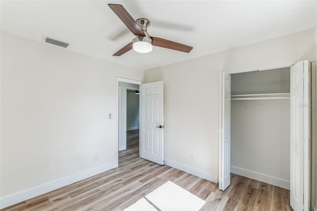 unfurnished bedroom with light hardwood / wood-style flooring, ceiling fan, and a closet