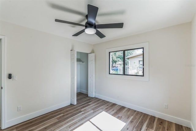 unfurnished bedroom with ceiling fan and light wood-type flooring