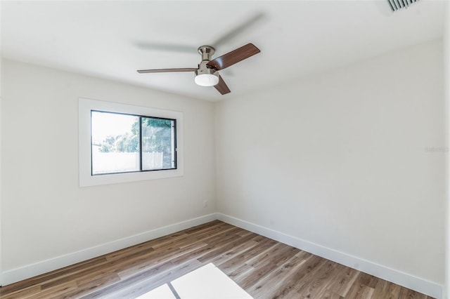 empty room with ceiling fan and light wood-type flooring