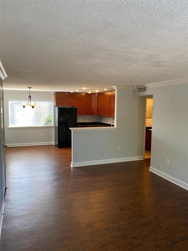 kitchen with a chandelier, black fridge with ice dispenser, visible vents, baseboards, and dark wood finished floors