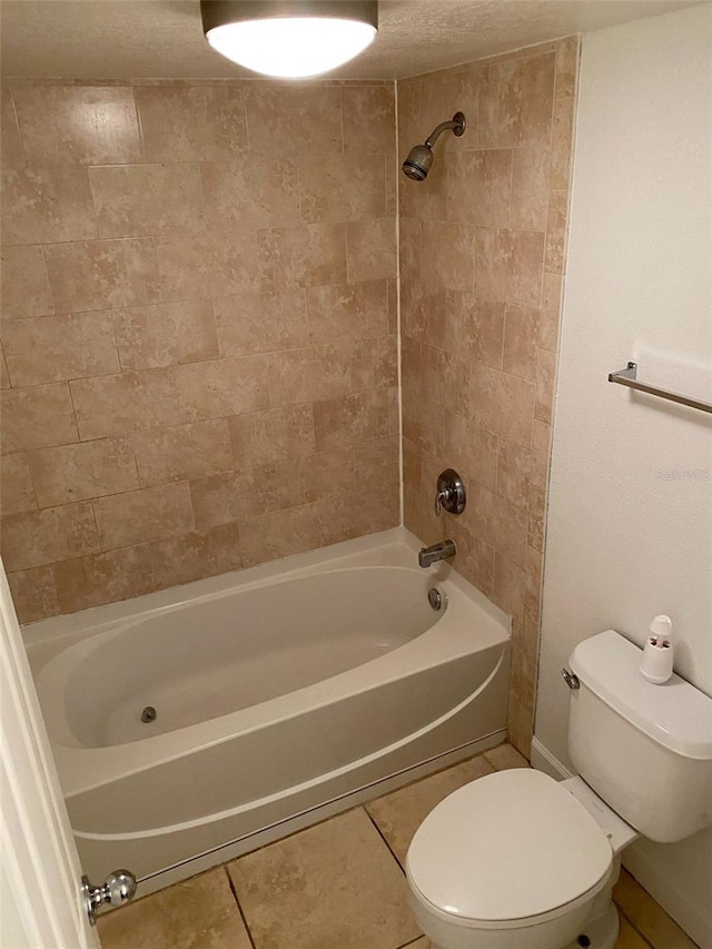 full bath with tile patterned flooring, shower / tub combination, and toilet