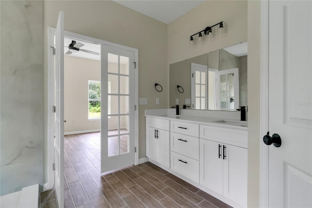 bathroom with ceiling fan, wood-type flooring, and double sink vanity