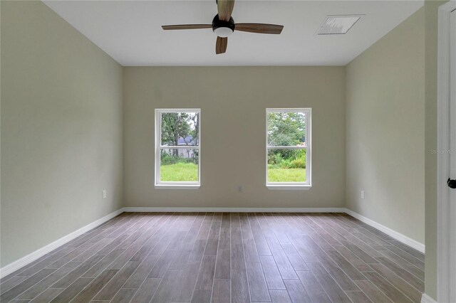 spare room with ceiling fan and dark wood-type flooring